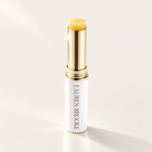 Lauren Brooke Eye Firming Crème stick in a white case with a gold barrel