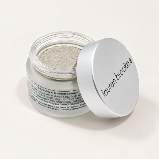 Lauren Brooke French Clay & Charcoal Masque powder in an open frosted jar with a silver lid