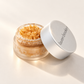 Lauren Brooke Organic Sweet Chai Lip Scrub in an open frosted jar with its lid beside it